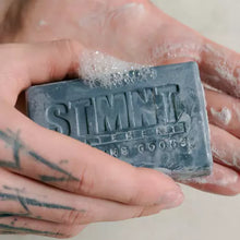 Load image into Gallery viewer, STMNT Hair &amp; Body Cleansing Bar For super clean hair, body, face and hands Moisturizing formula with activated charcoal gently removes impurities Practical, easy-to-use bar Ideal for the gym and travel Free from sulfates (SLS*) and silicones
