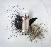 Load image into Gallery viewer, The heavy-duty IGK charcoal dry shampoo extends the time between washes after exercise as well. The detoxifying charcoal powder absorbs oil and sweat while also removing impurities from the scalp. White tea powder, which is both cooling and soothing, stimulates hair growth and regenerates the scalp.
